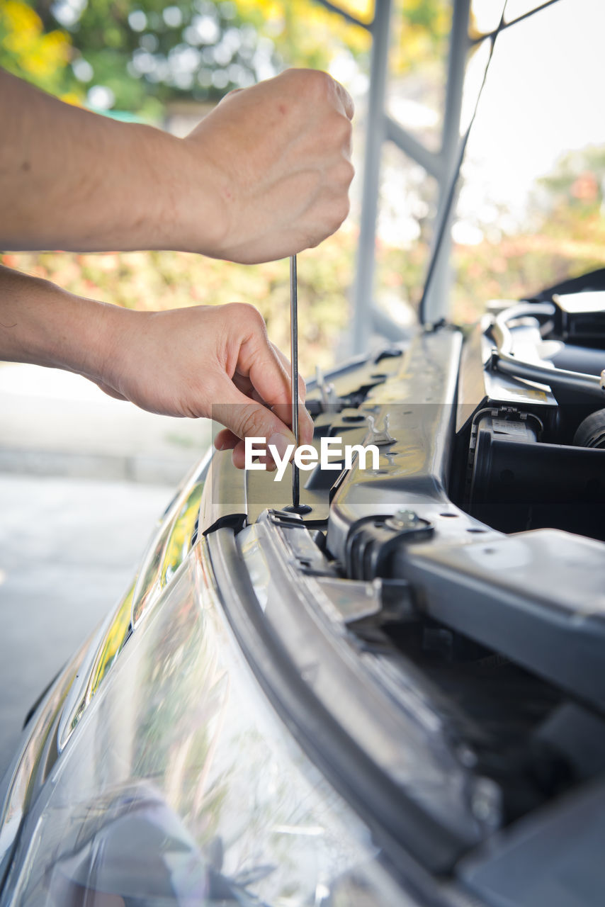 Auto mechanic checking car engine,worker selective focus