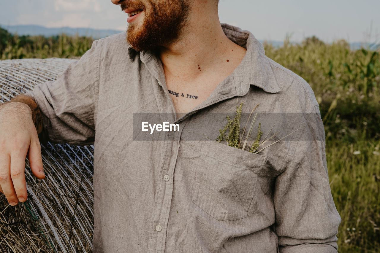 Midsection of man standing in farm