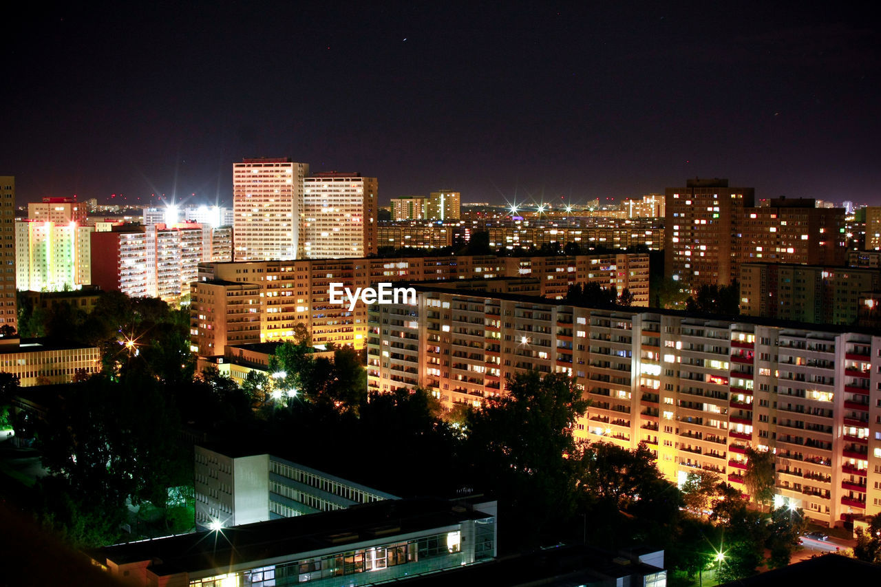 High angle view of illuminated buildings in city at night