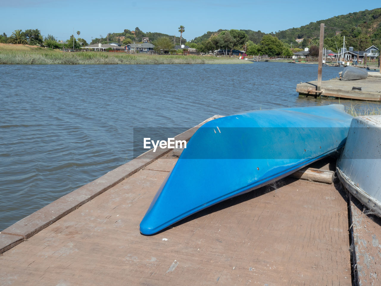 BLUE BOAT MOORED IN LAKE