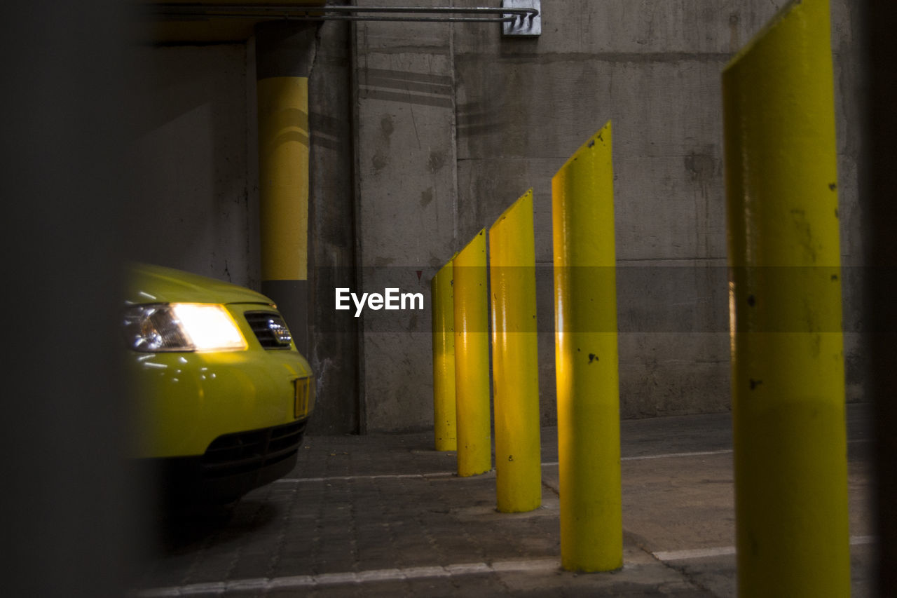 YELLOW CAR PARKED IN CITY