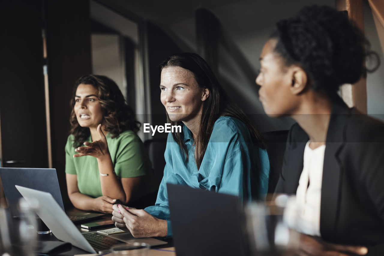 Multiracial businesswomen planning strategy during meeting at office