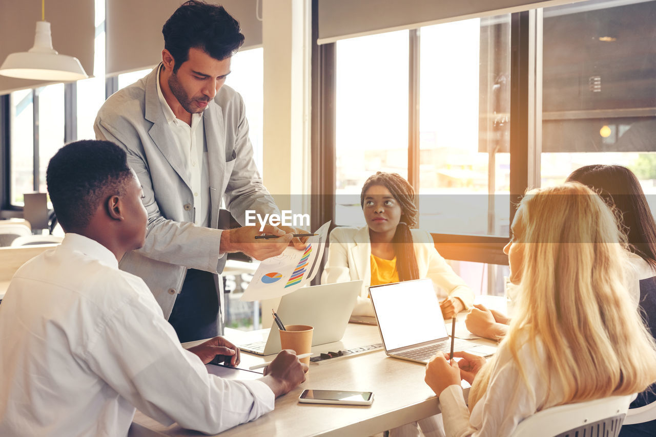 Selective focus of multi-ethnic group of young people studying together