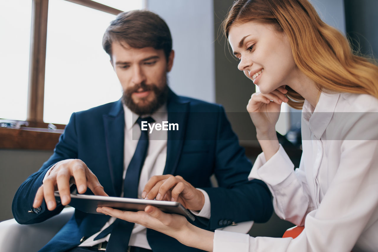 Business colleagues using digital tablet