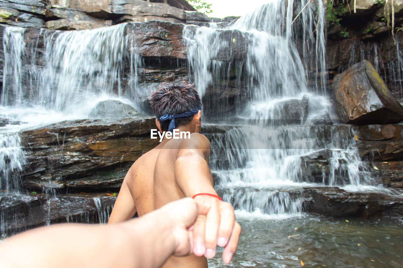 Man looking at waterfall