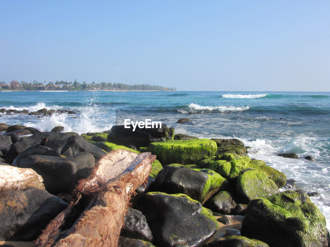 Scenic view of sea against clear blue sky