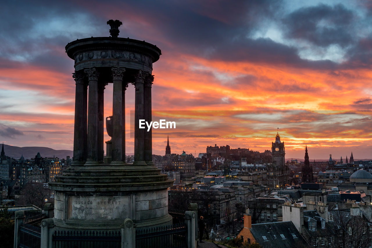 TOWER IN CITY DURING SUNSET