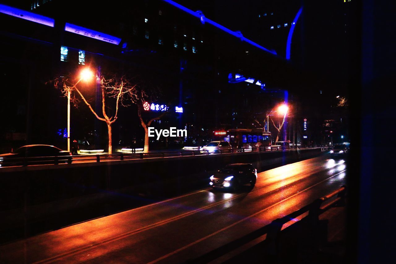 LIGHT TRAILS ON ROAD AT NIGHT