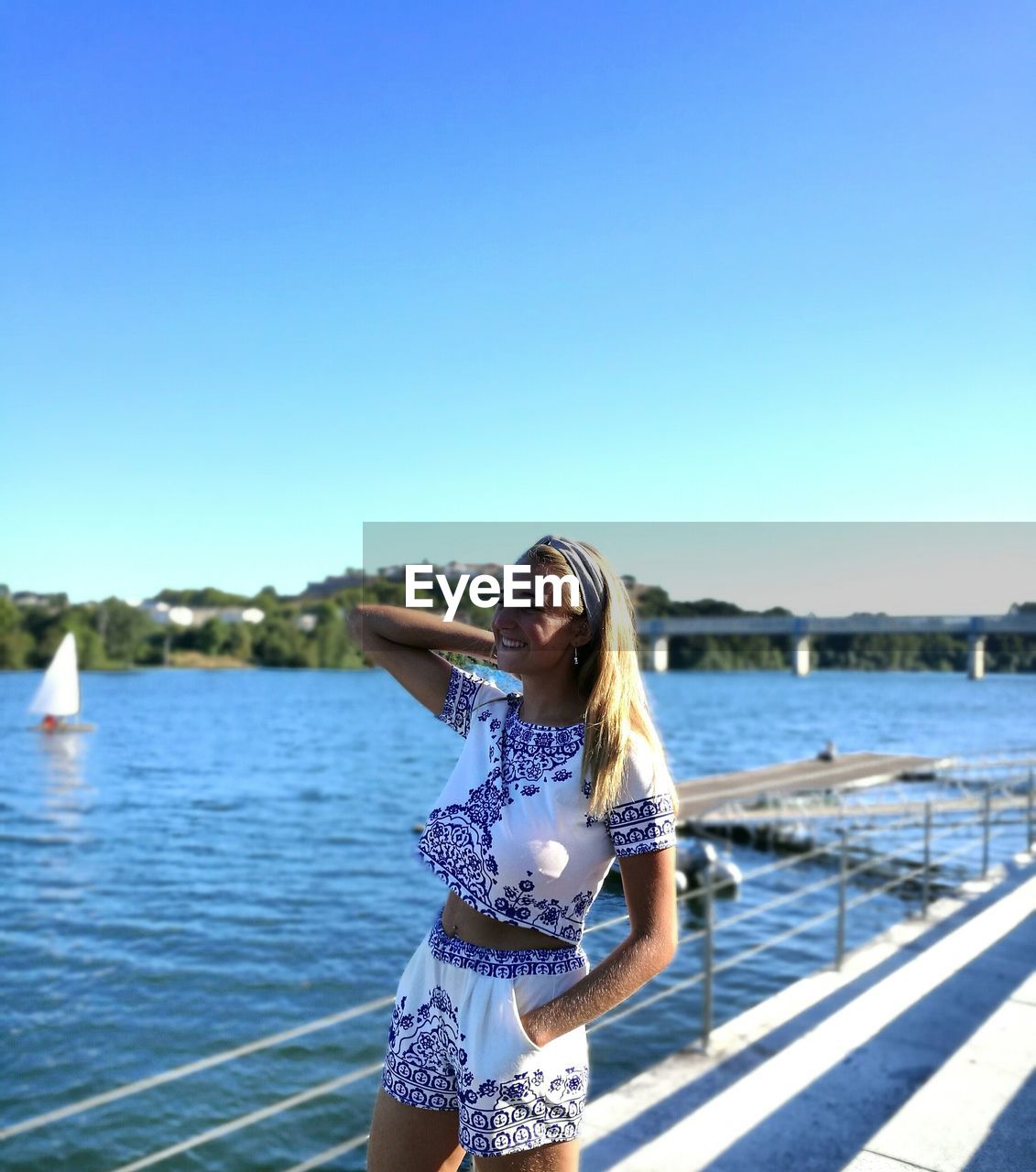 Portrait of woman standing on pier