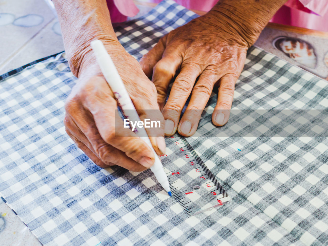 MIDSECTION OF MAN WORKING ON TABLE