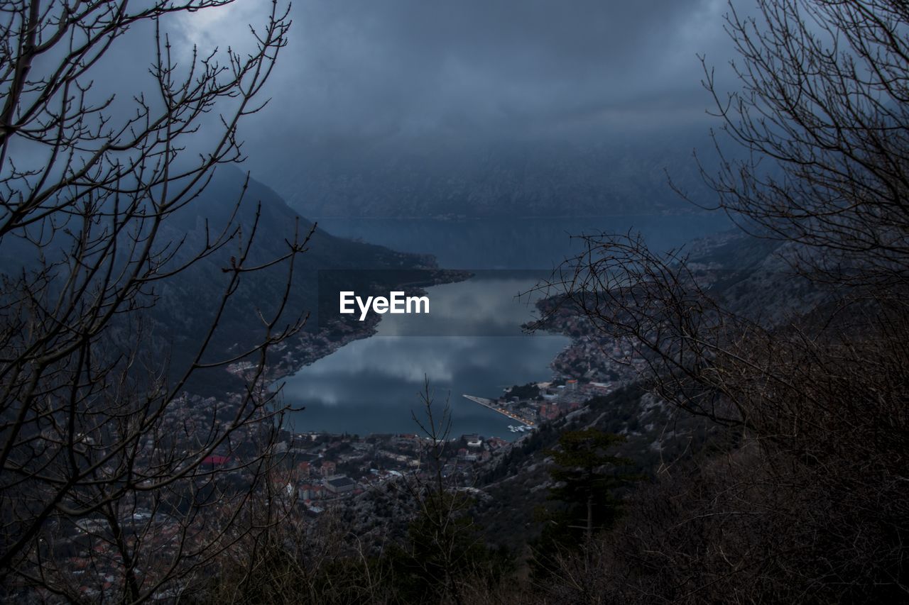 Scenic view of trees and mountains against sky