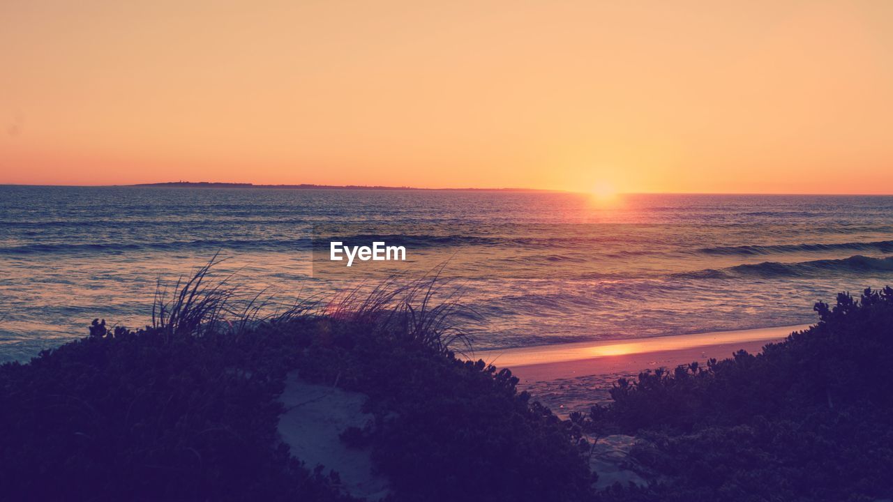 Scenic view of sea against sky during sunset