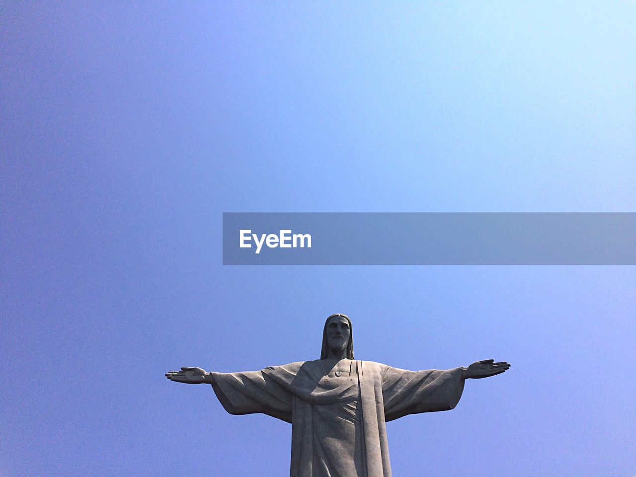 Low angle view of christ the redeemer against clear blue sky