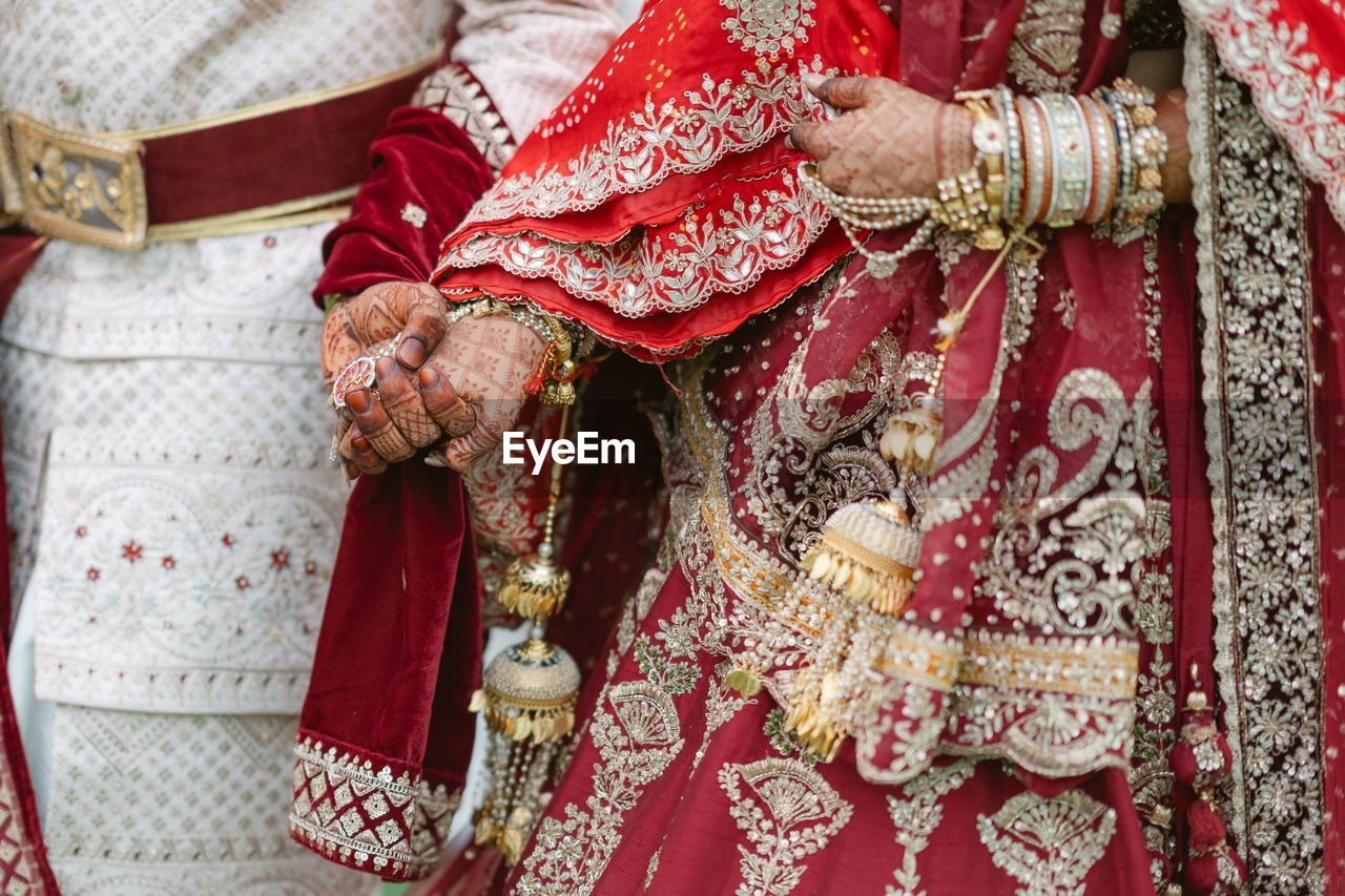 midsection of woman wearing wedding dress