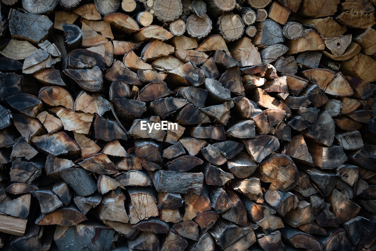 large group of objects, firewood, log, abundance, timber, wood, lumber industry, backgrounds, full frame, forest, deforestation, rock, power generation, soil, environmental issues, tree, woodpile, no people, fossil fuel, wall, nature, stone wall, heap, pattern, textured, day, outdoors, environmental damage, brown, close-up, road surface