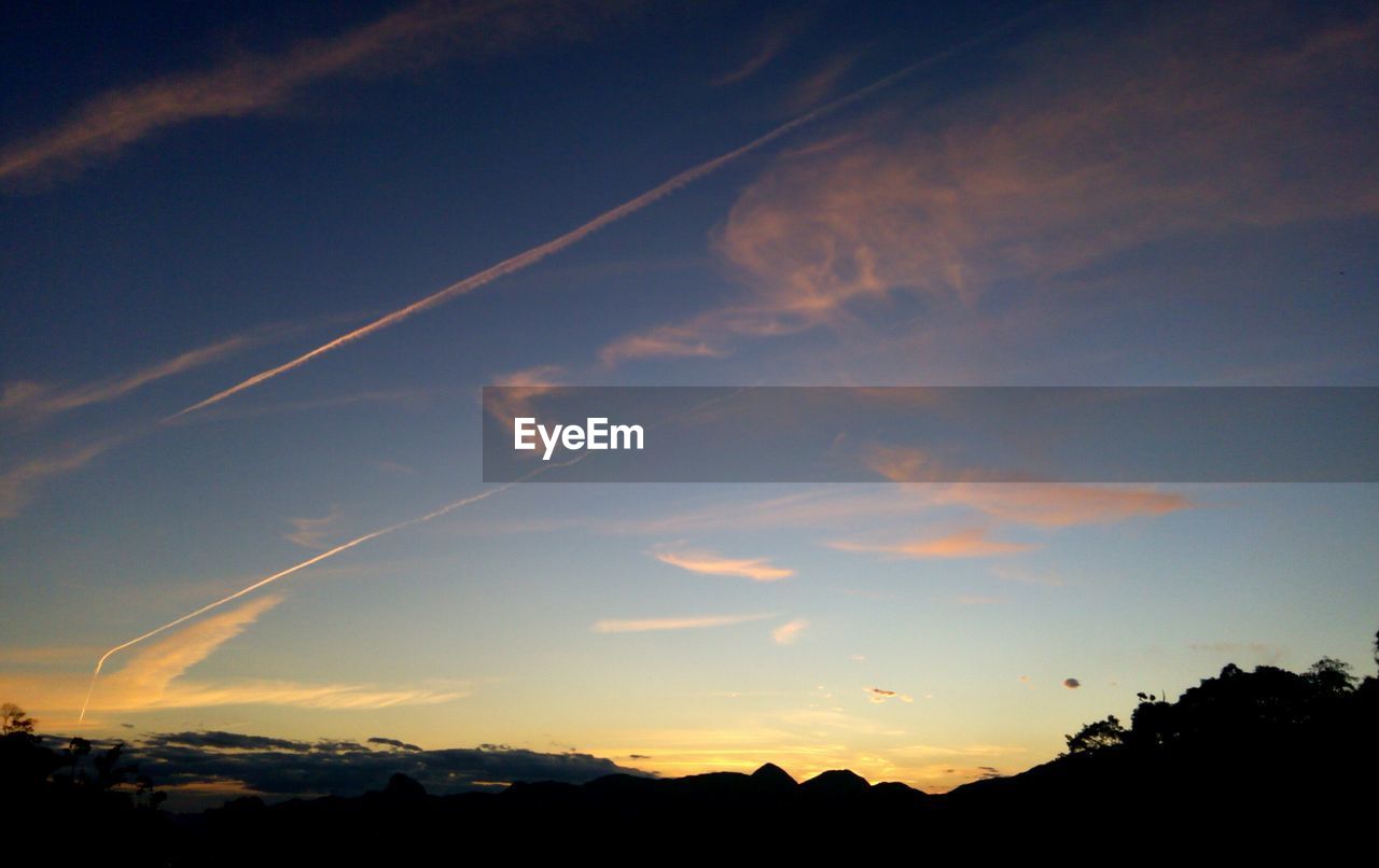 SILHOUETTE OF LANDSCAPE AGAINST SUNSET