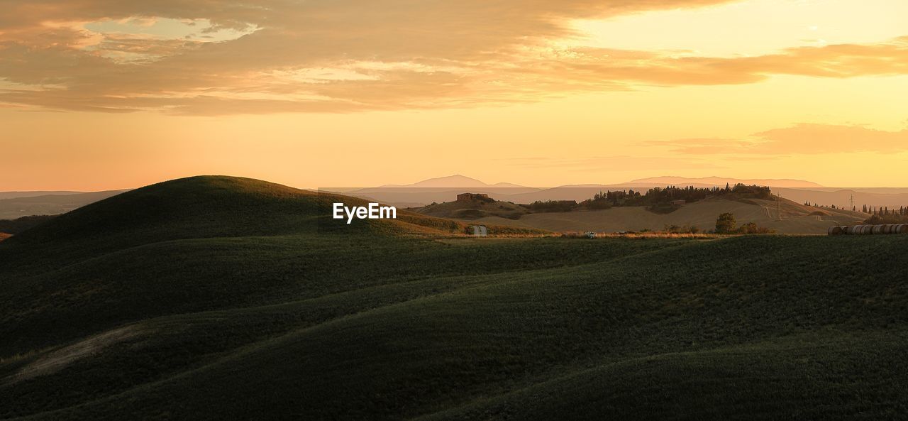 Scenic view of field against sky during sunset