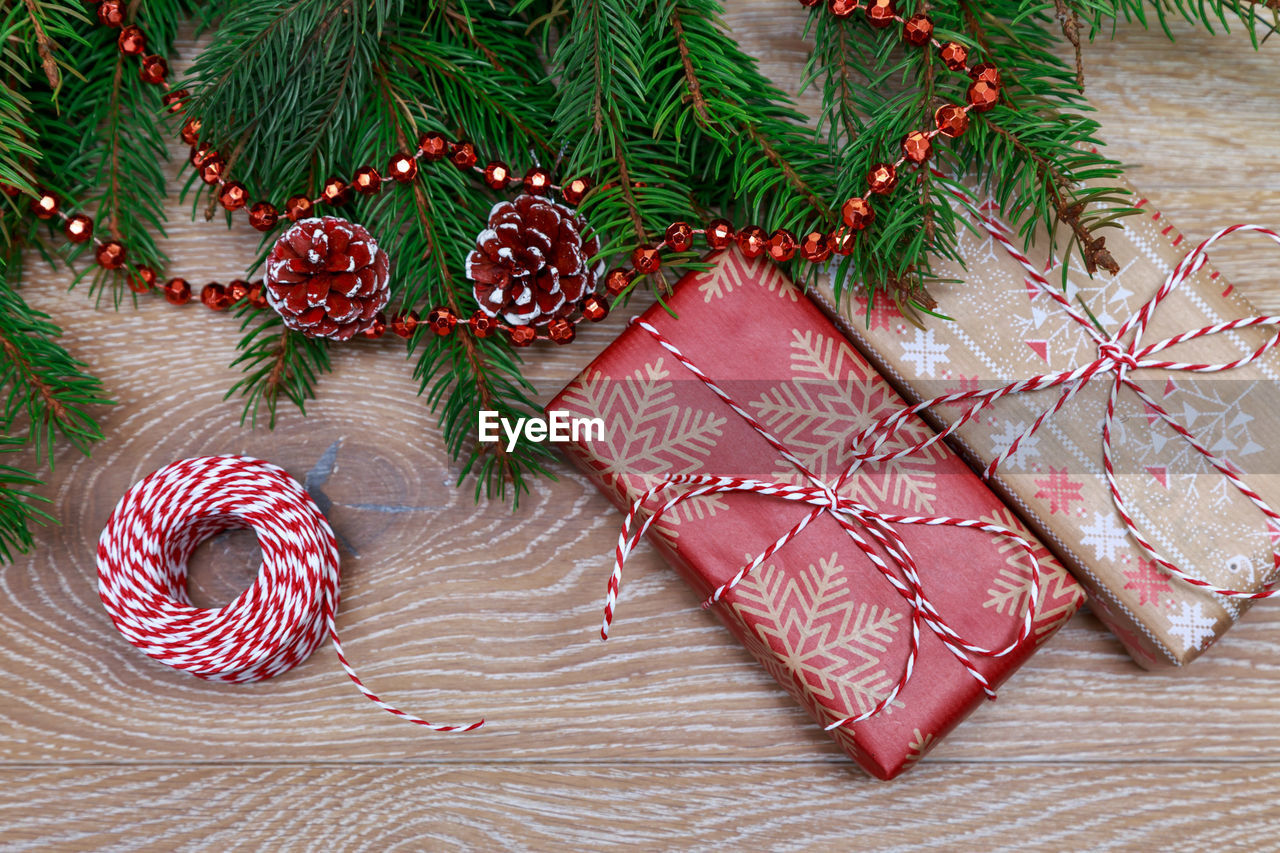 Close-up of christmas tree and gifts on table