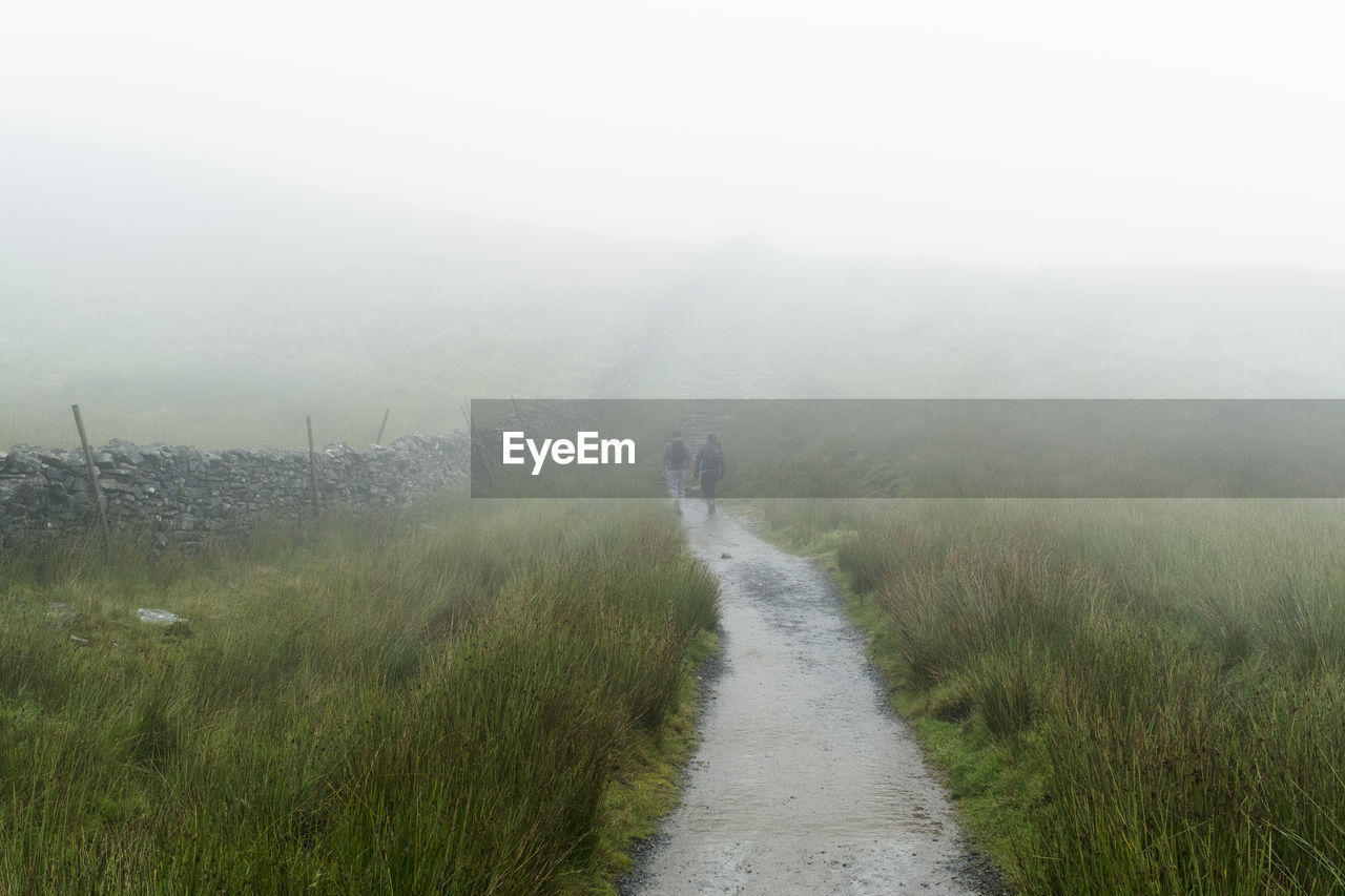 Footpath in countryside in foggy weather