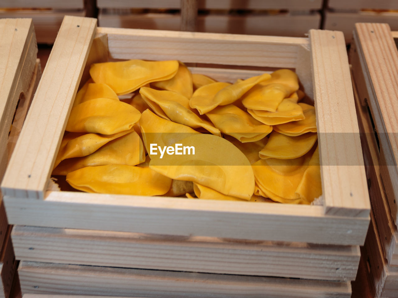 HIGH ANGLE VIEW OF YELLOW FOOD ON WOODEN TABLE