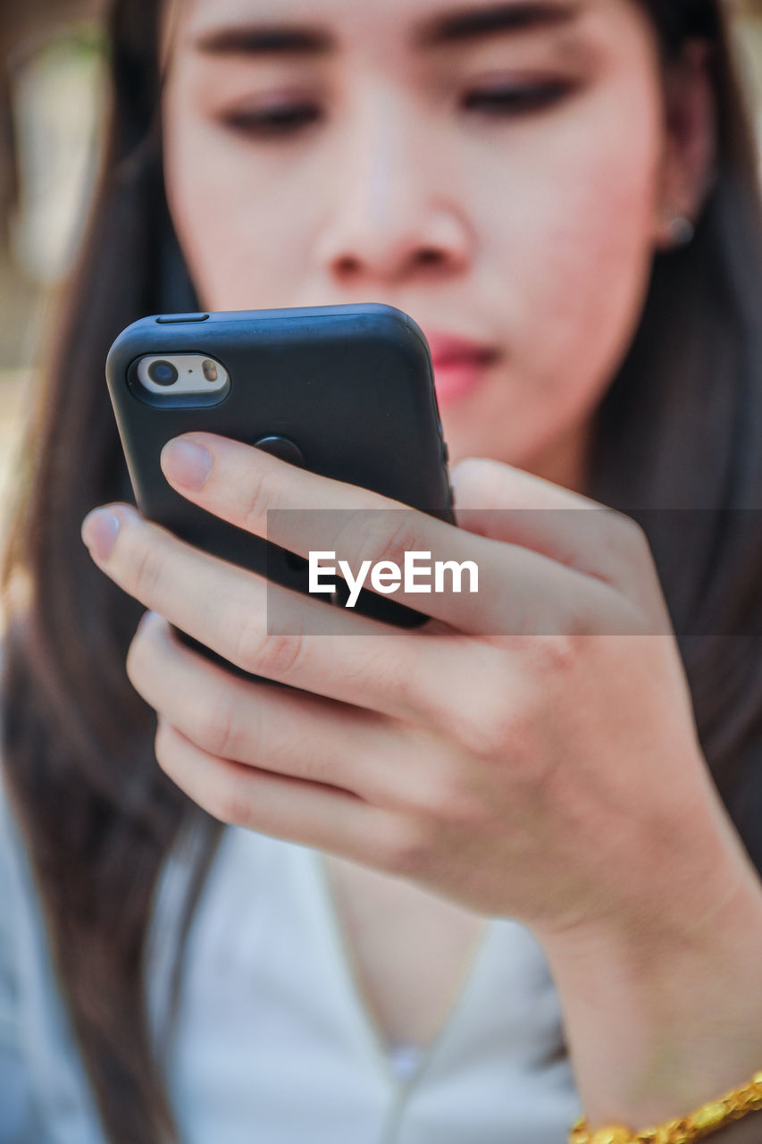 Close-up of woman using mobile phone