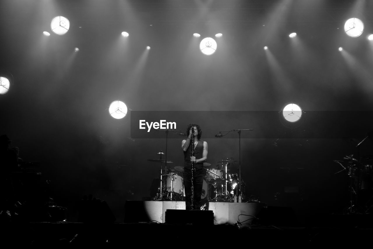 Man singing on stage during concert
