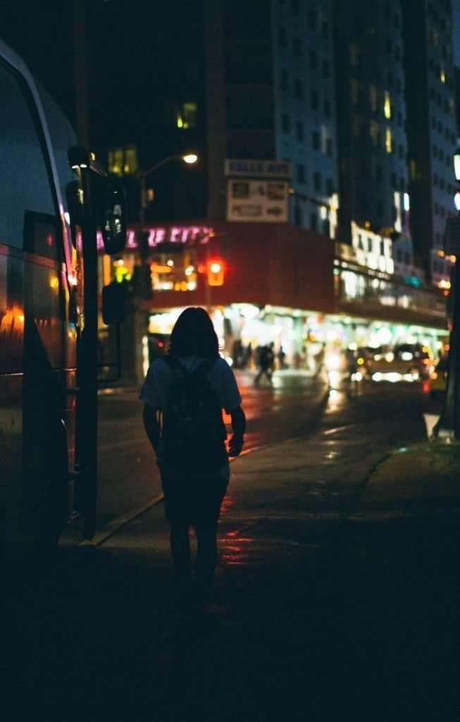 WOMAN IN CITY AT NIGHT