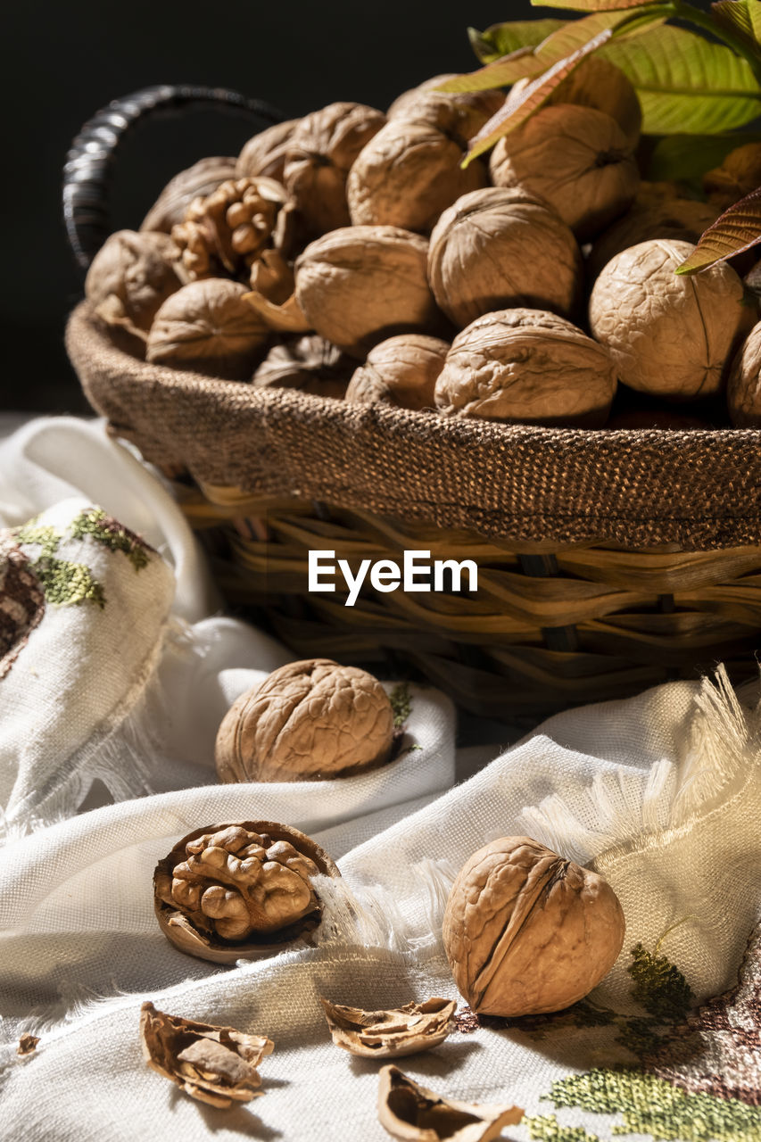 Whole walnuts in basket, food harvest, rustic style