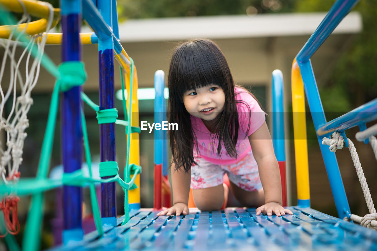 Smiling girl playing at playground