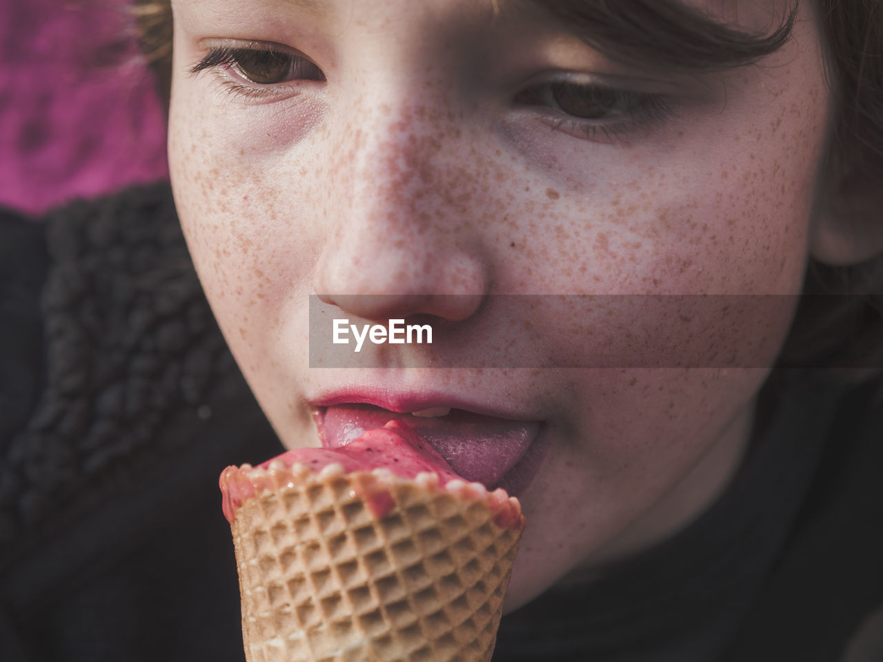 Close-up of boy licking ice cream