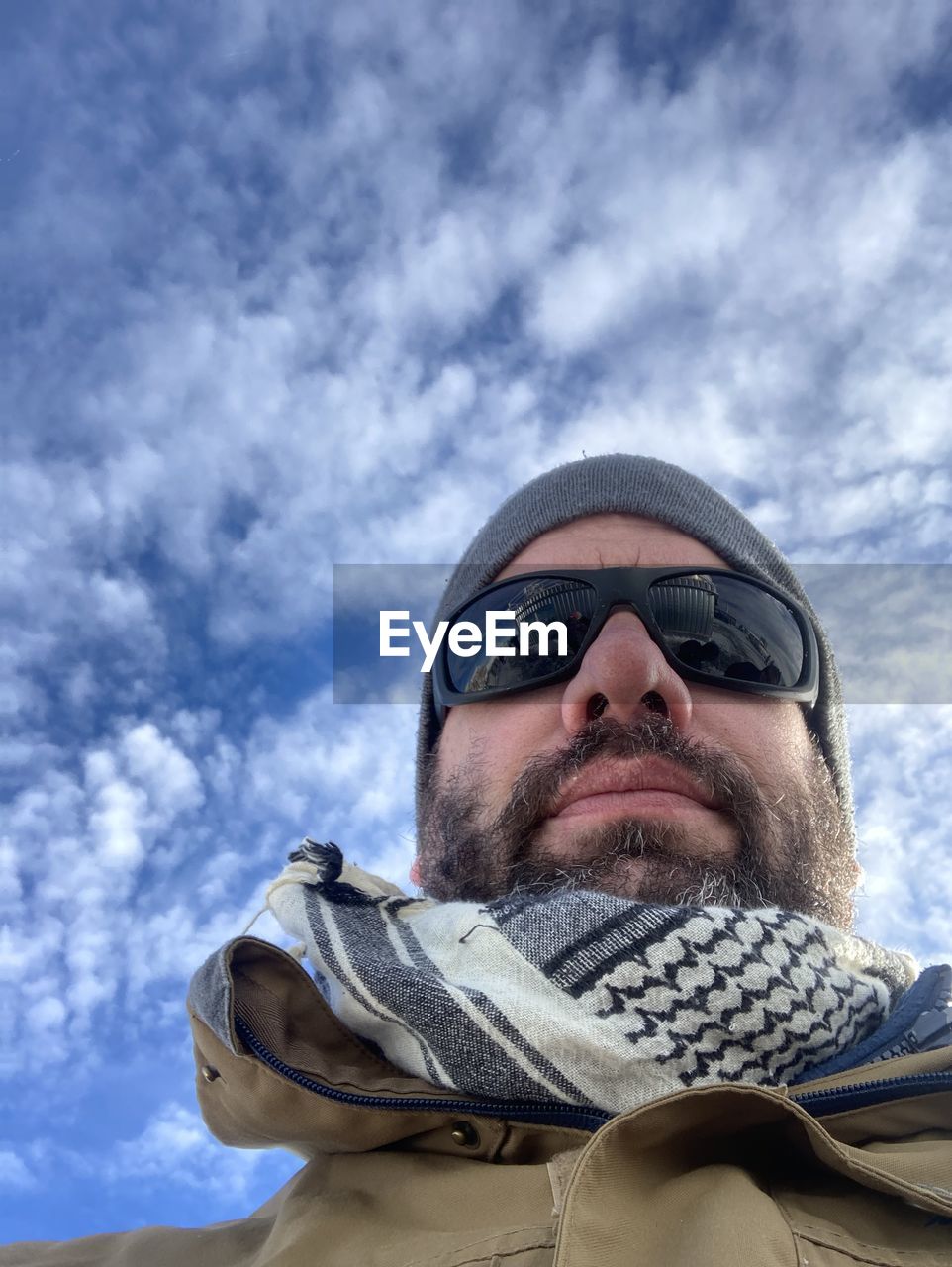 cloud, sky, one person, adult, blue, nature, men, leisure activity, day, sports, low angle view, portrait, young adult, clothing, outdoors, lifestyles, extreme sports, winter, snow, cold temperature, emotion, headshot, activity, looking, warm clothing, adventure