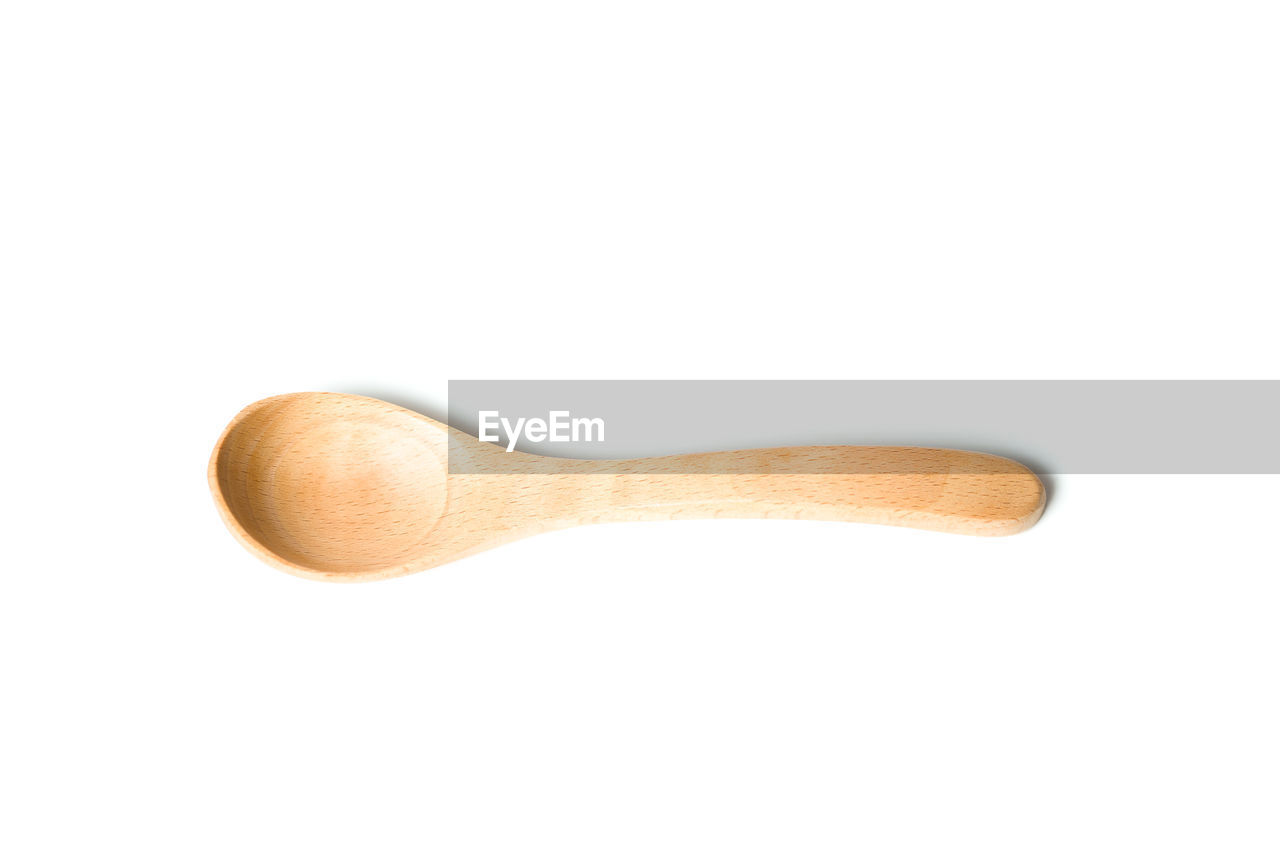 Wooden spoon over white background
