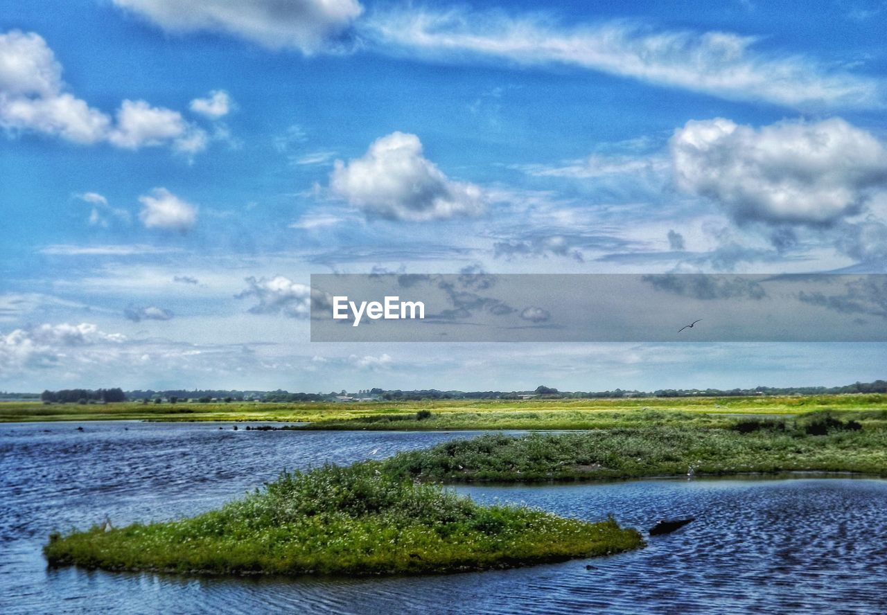 Scenic view of landscape against cloudy sky