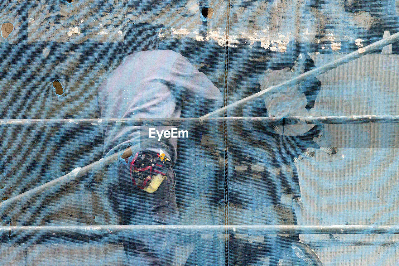 CLOSE-UP OF MAN WITH UMBRELLA ON BACKGROUND