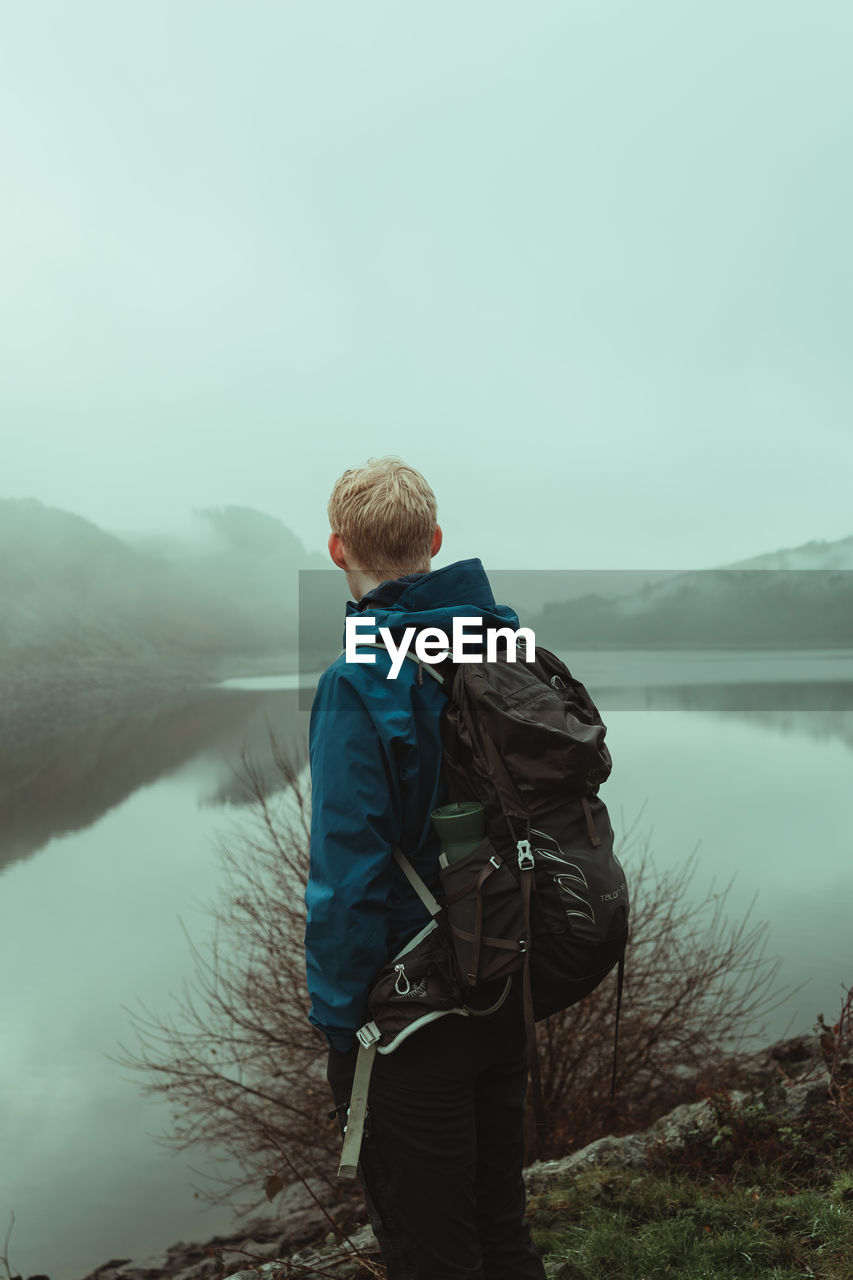 Man exploring a misty welsh valley 