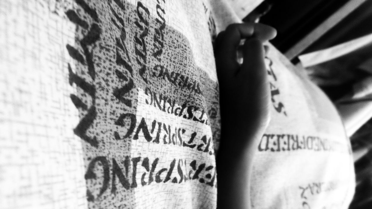 Close-up of hand on bed sheet