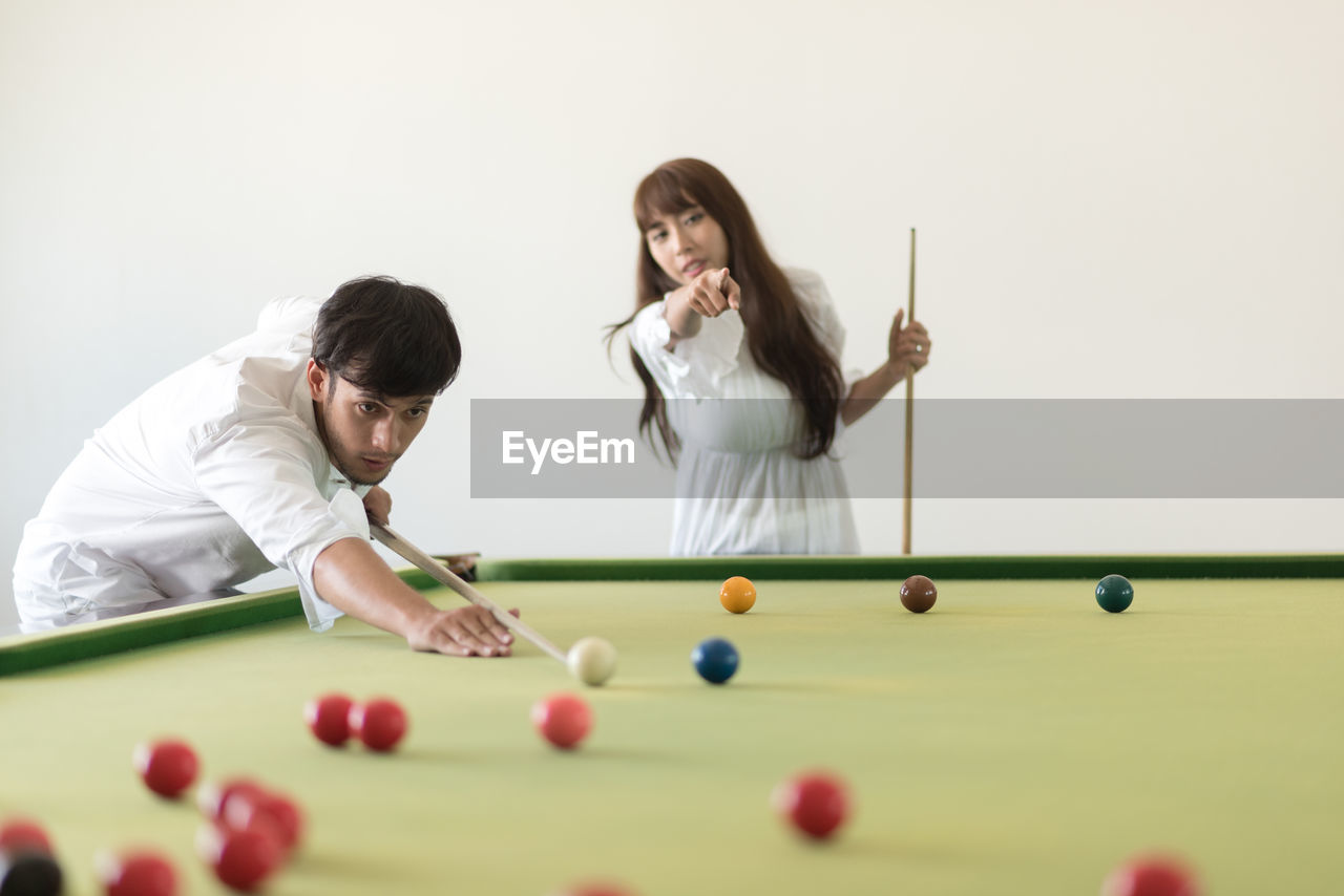 YOUNG WOMAN PLAYING WITH BALL AND TABLE