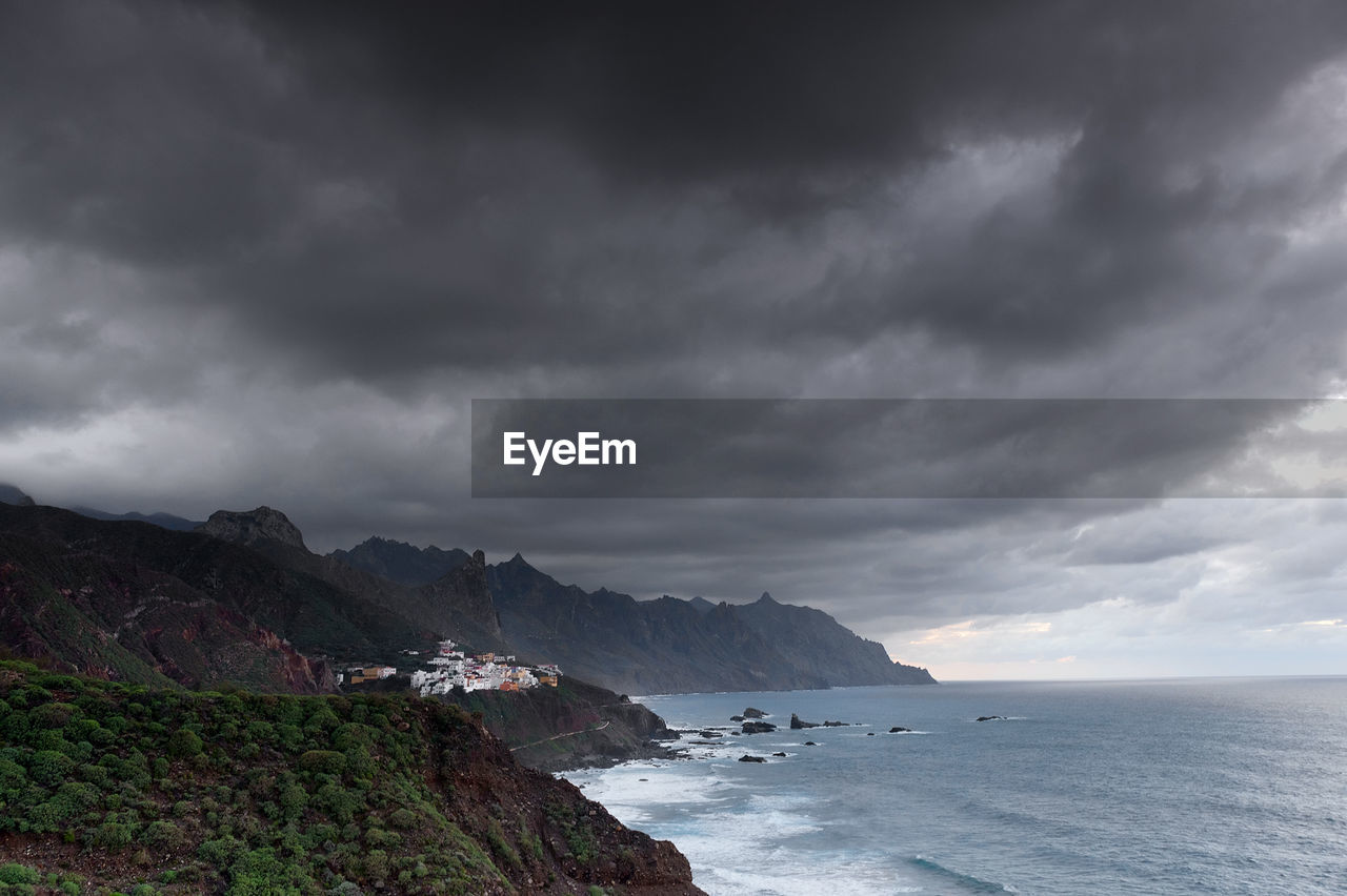 Coastal feature against cloudy sky