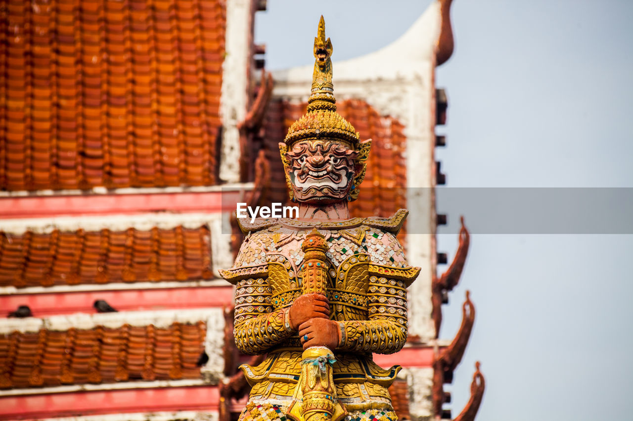 Statue of temple against building