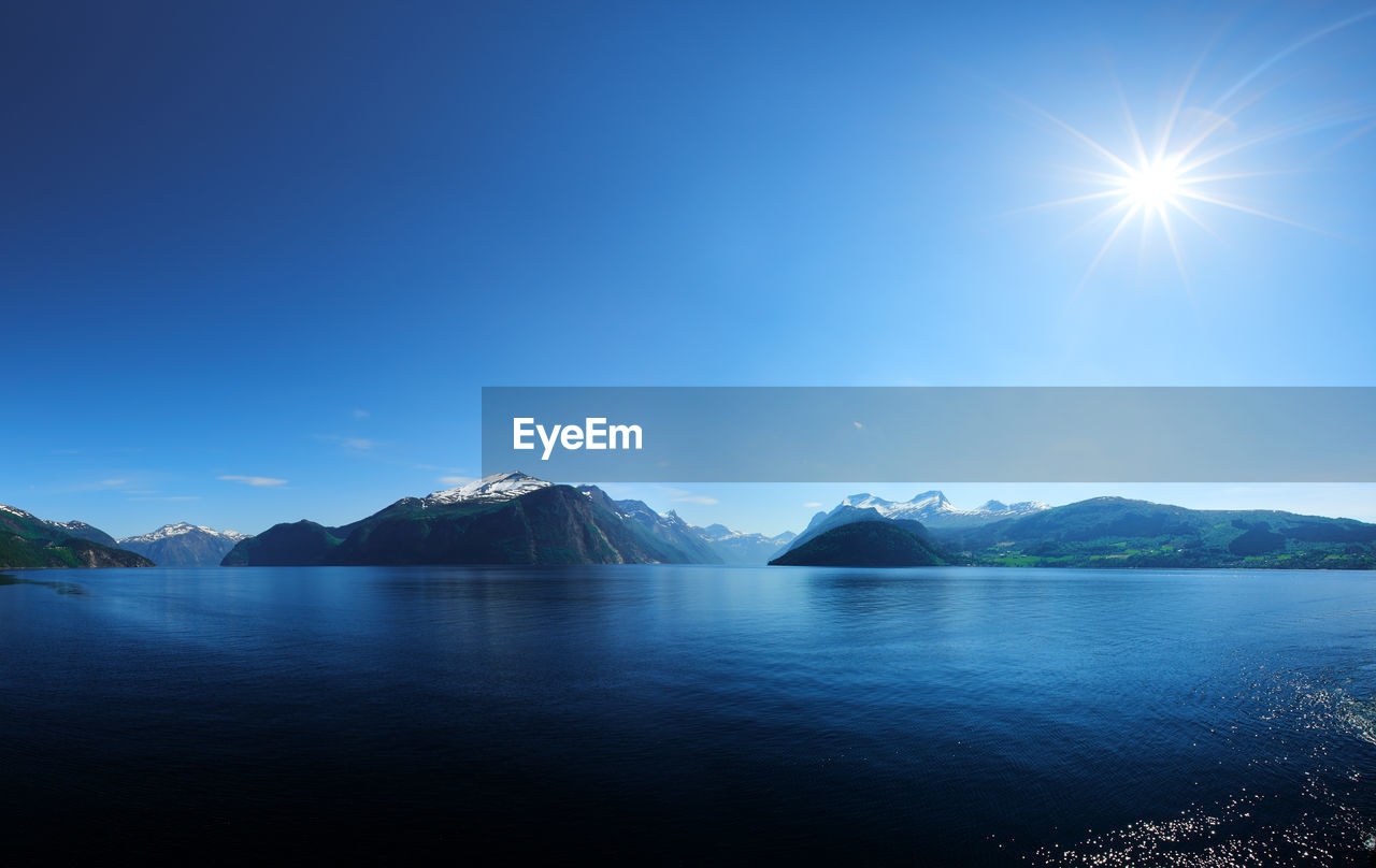 Scenic view of sea against blue sky