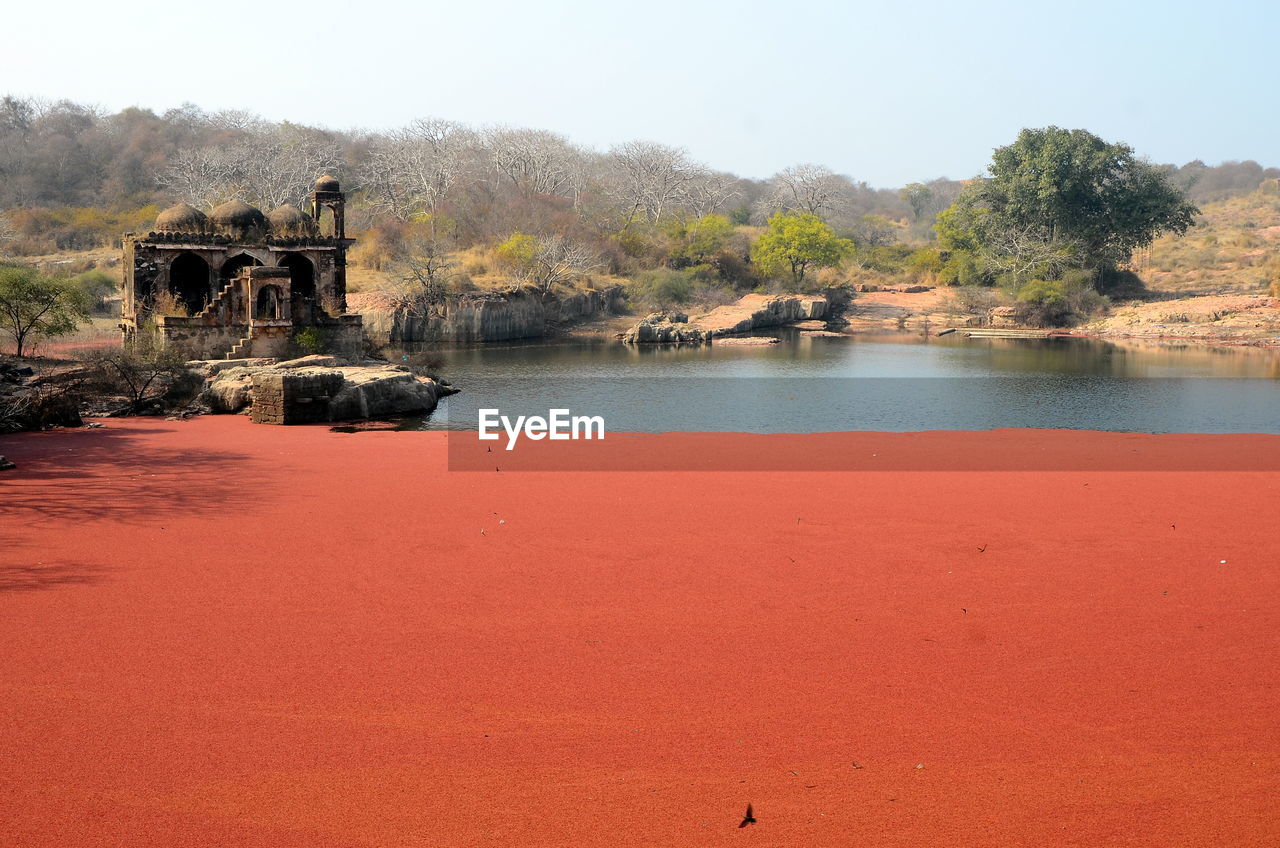 Scenic view of calm lake against blue sky