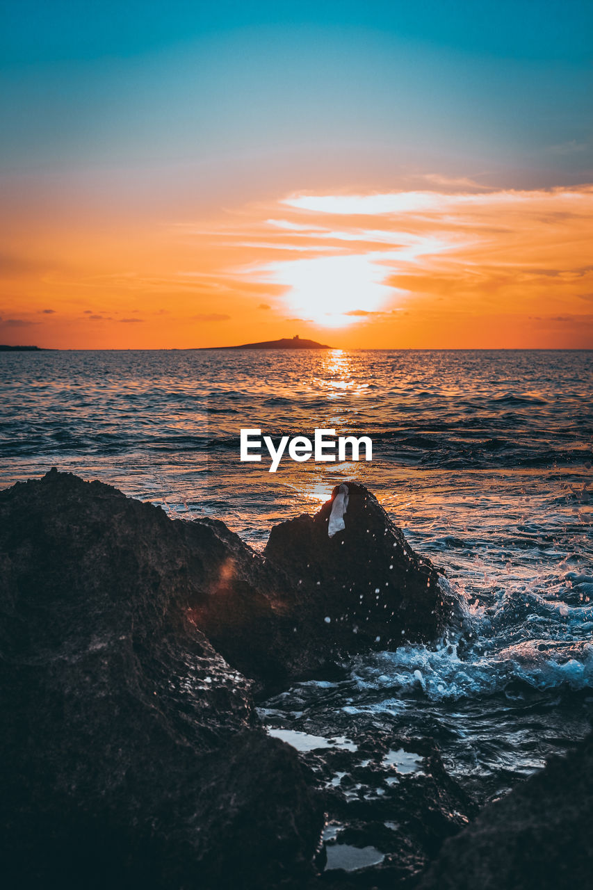 Scenic view of sea against sky during sunset