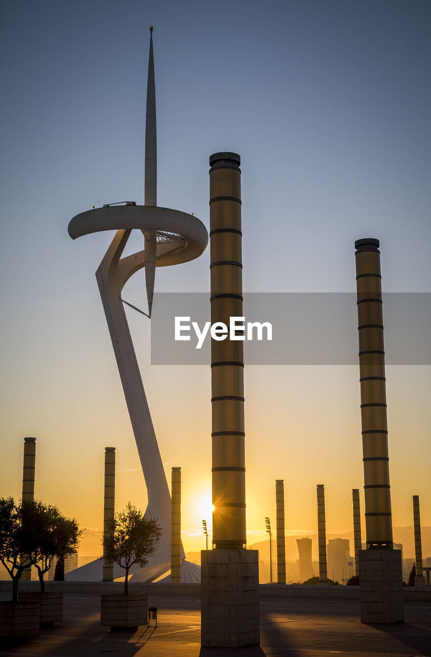 Buildings against clear sky at sunset