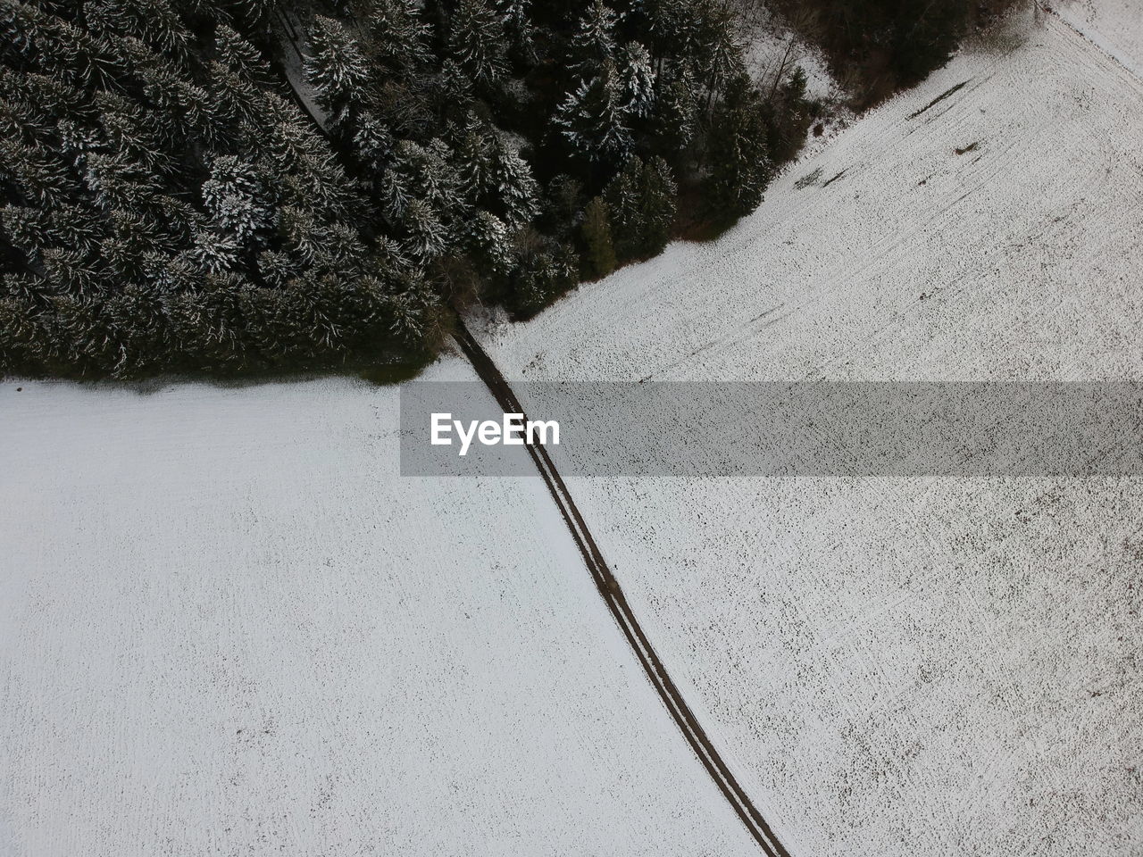 snow, winter, high angle view, nature, day, no people, soil, asphalt, plant, cold temperature, land, scenics - nature, beauty in nature, outdoors, environment, road, tree, transportation, road surface, tranquility, non-urban scene, landscape