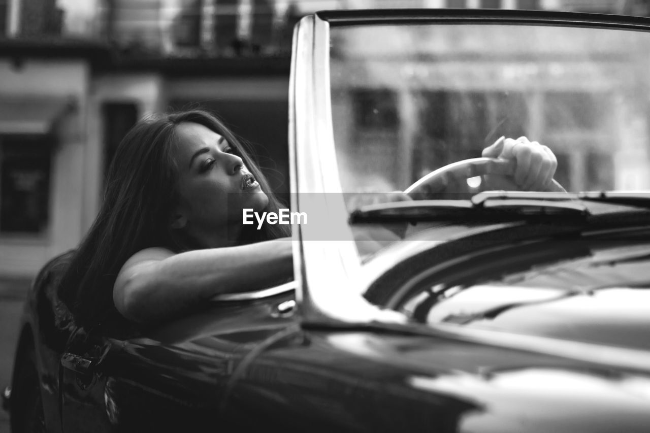 Young woman driving convertible