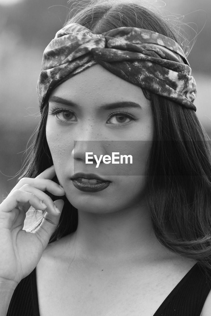 Close-up portrait of beautiful young woman wearing bandana