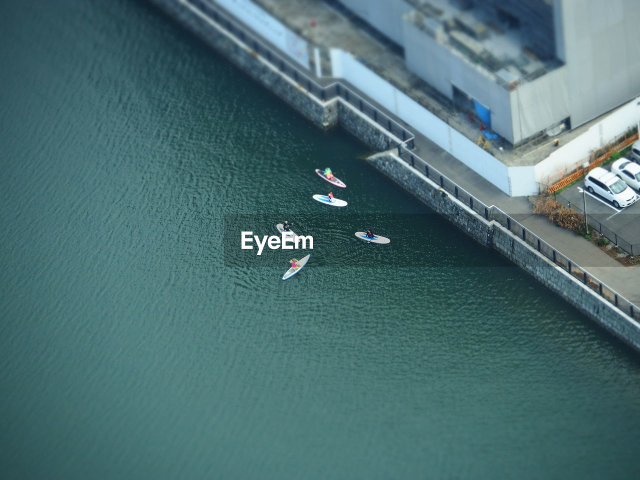 Aerial view of people paddleboarding on river