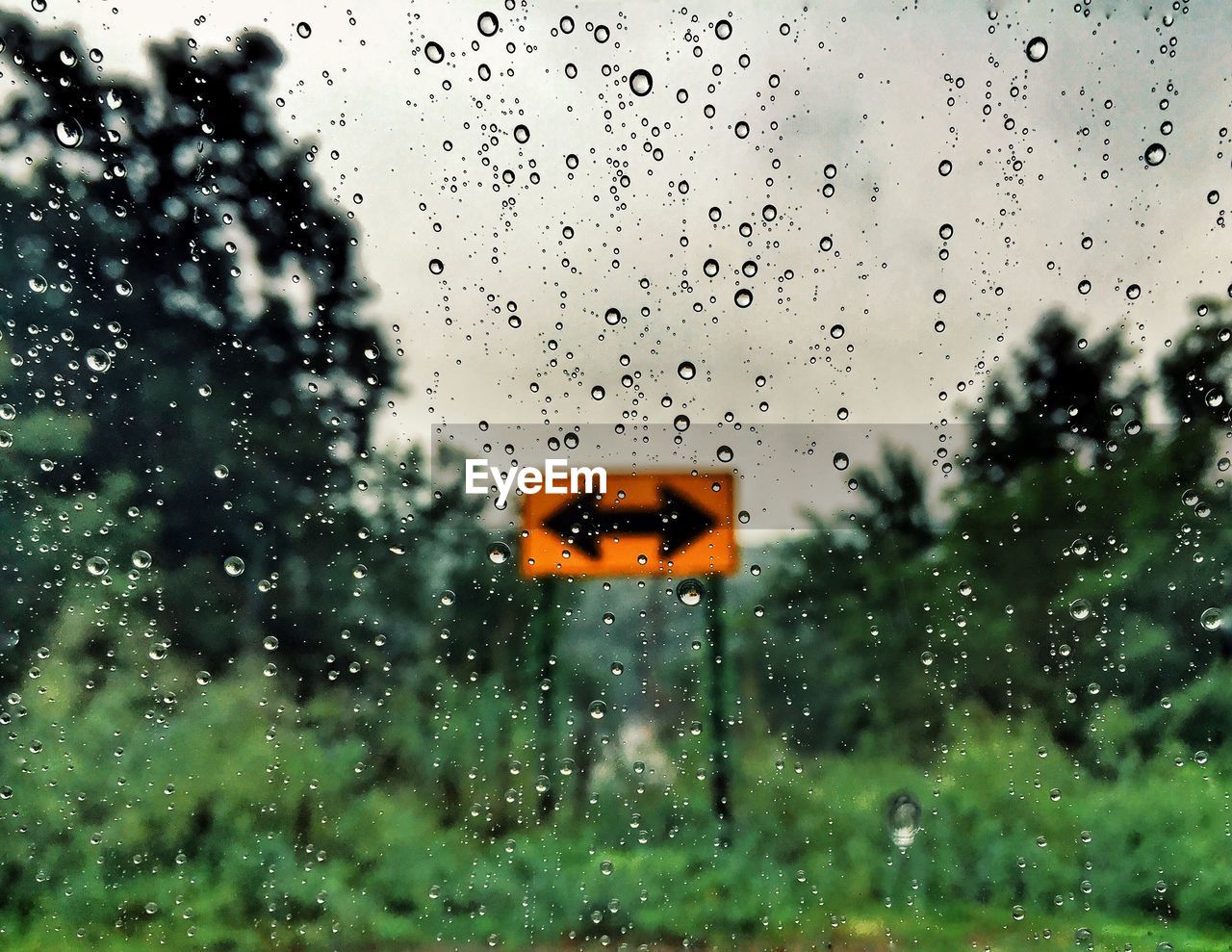 Raindrops on glass window in rainy season