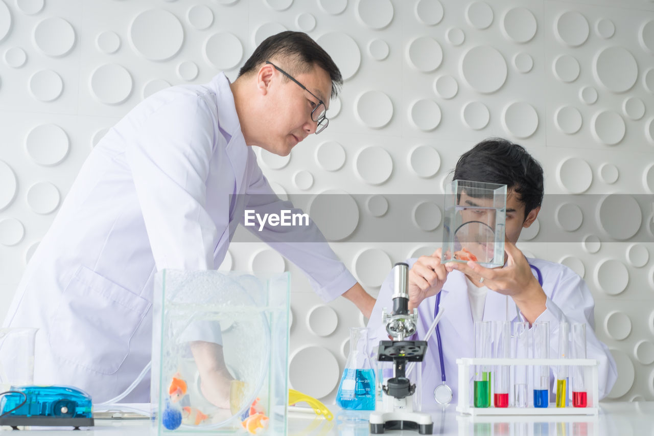 Scientists performing scientific experiment at laboratory