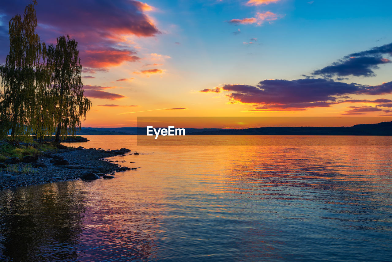 scenic view of sunset over lake